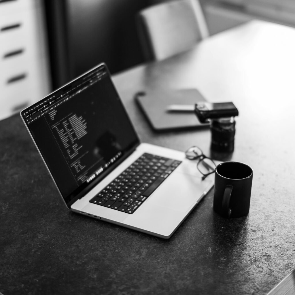 Young hacker coding in a dark room