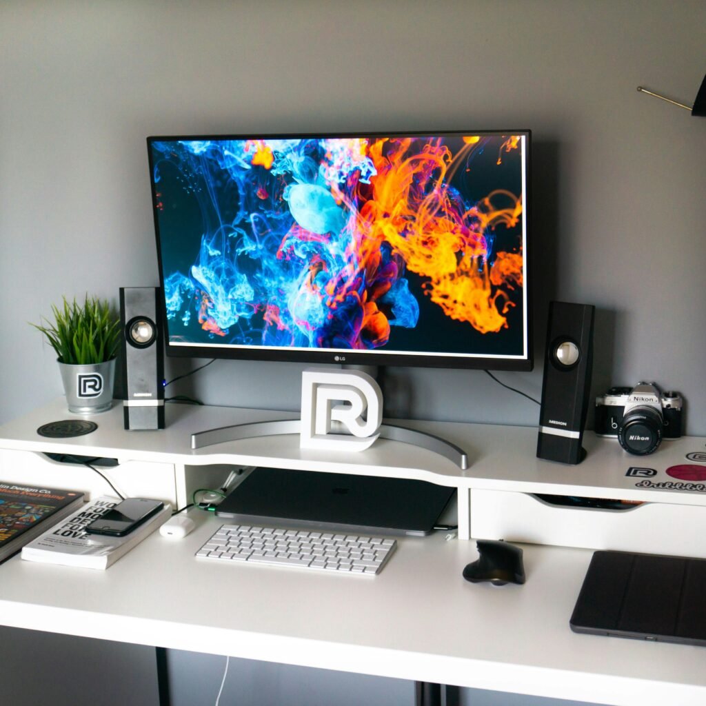 Complete gaming setup with PC, monitors, headset, and controller